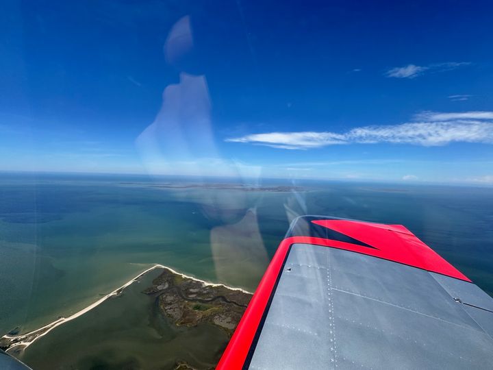 Tangier Island and its shoreline seen from an RV approaching over the Chesapeake Bay.