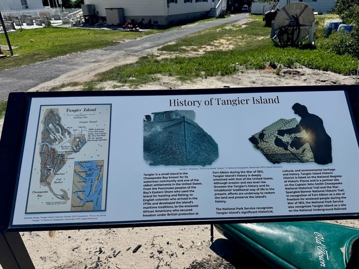 An outdoor sign describing the history and changing geography of Tangier Island.